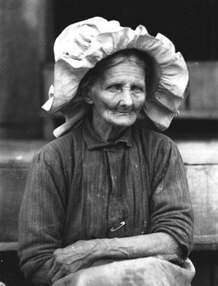 Elderly woman, wearing a bonnet