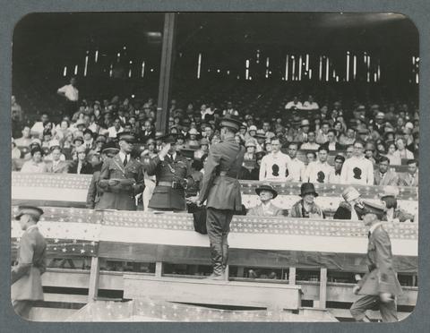 Officers saluting each other in stands, circa 1930