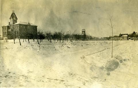 Administration Building, college orchard, and the greenhouse in the snow