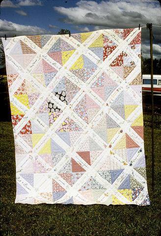65 x 85 inch started by Emma Jensen's daughter in Can.(?). Sent squares to family and friends, got pieces back for Emma Jensen's birthday in 1939 but never got around to quilt it. Hattie and Marguerite quilted it about 1955. (Don't know why 1966 is on it.) Junction City