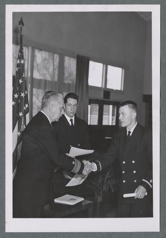 Naval ROTC cadet receiving diploma/certificate, circa 1950