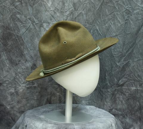 Man's Campaign hat of olive drab suede leather with grosgrain ribbon with varying ribs, and cord ties (maybe cavalry blue)