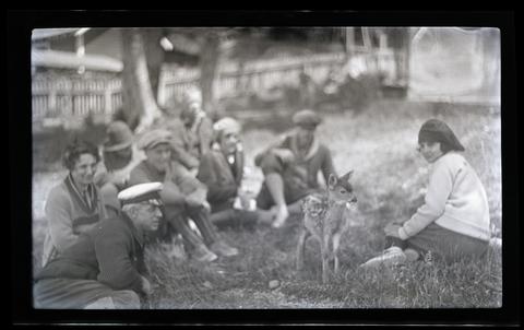 A group of people with a fawn