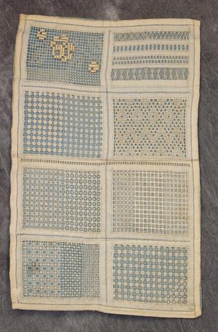 onvent sampler of a variety of open-work lace stitches with a blue silk back that shows through